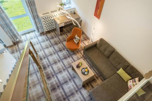 an overhead view of a living room with a couch and a chair at Hotel Chrysantihof in Bad Birnbach