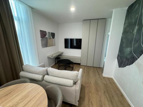 a living room with a couch and a table at Enjoy Apartments and Suites in Zagreb