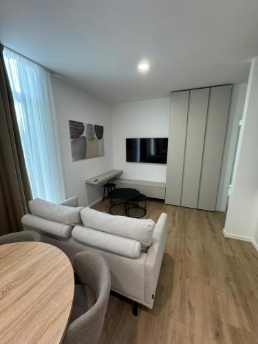 a living room with a couch and a table at Enjoy Apartments and Suites in Zagreb