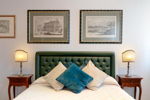 a bedroom with a green bed with two night stands at Ca' Santo Spirito B&B in Venice