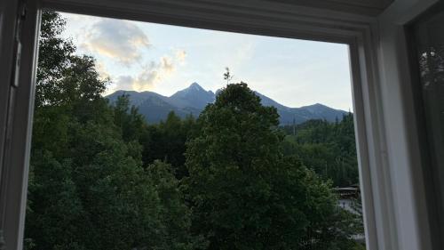 a view of a mountain from a window at Mountain Peak Apartment in Tatranská Lomnica