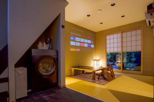 a laundry room with a table and a washing machine at Kyoki Machiya near Kyoto Station Exquisite Garden in Kyoto