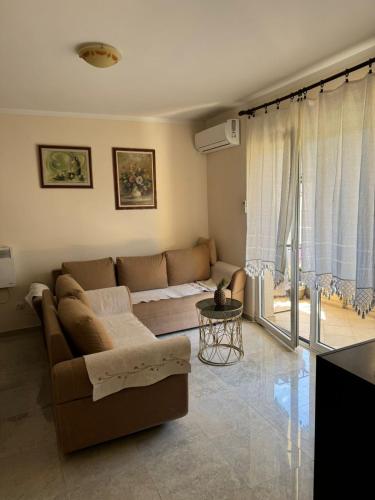 a living room with a couch and a table at Apartman Tafra 3 in Igalo