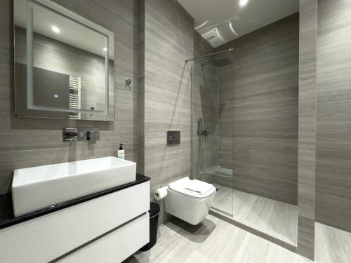 a bathroom with a sink and a toilet and a shower at VILLA 8 By ProLiving Hospitality in Thessaloniki