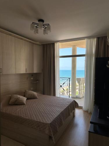 a bedroom with a bed with a view of the ocean at 2 bedroom apartment komplex Andalusia Elenite with terrasa and sea in Sveti Vlas
