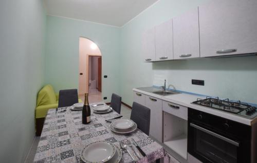 a kitchen with a table with a bottle of wine on it at Nice Apartment In Palmi With Wifi in Palmi