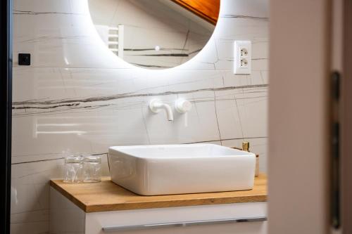 a bathroom with a white sink and a mirror at Villa Jidro in Trogir