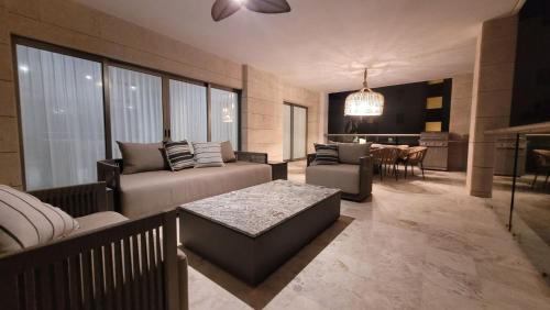 a living room with a couch and a table at Luxurious Apartment La Amada Ocean View in Cancún