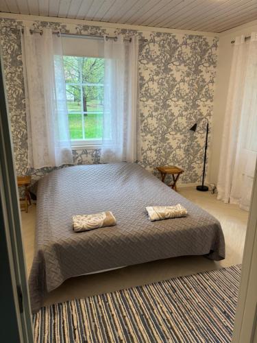 a bedroom with a bed with two pillows on it at Wallinkoski accommodation - Rooms and Tentsile tent options next to River Vuoksi in Imatra