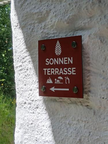 a sign on a wall that reads summer terrace at Bergvilla Vivaldi - Happy Mountain Vibes in Mühlbach am Hochkönig