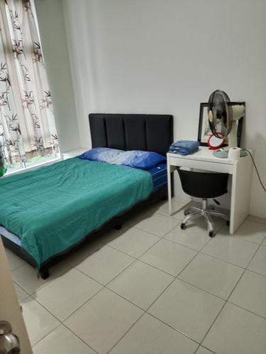 a bedroom with a bed and a desk and a chair at Anderson Condo ipoh in Ipoh