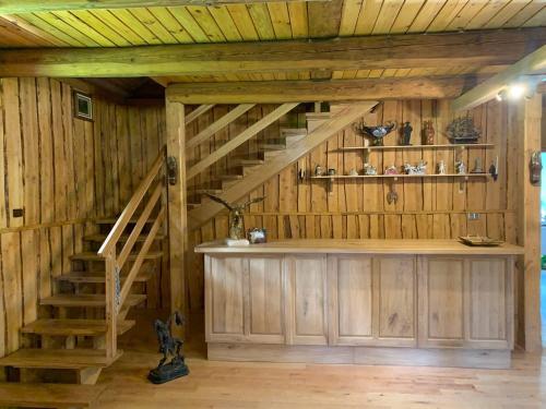 a room with a staircase in a wooden house at Zacisze Ośmiu Stawów Siekierczyna - The Quort of Eight Pounds 