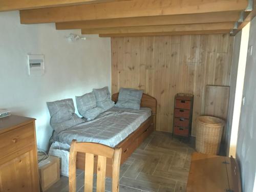 une chambre avec un lit et un mur en bois dans l'établissement Havre de Paix à 20 Min de Nice, à Levens