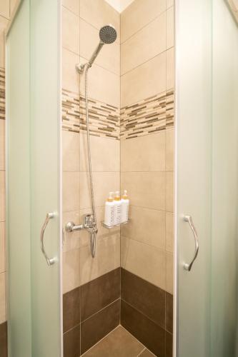 a shower with a glass door in a bathroom at Kyra's Luxury Suites 4 in Chios