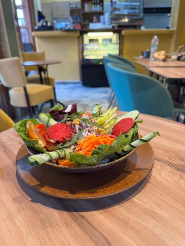 a bowl of salad sitting on a table at Playa Surf House in Tamraght Ouzdar