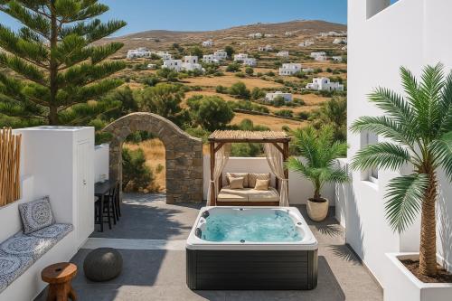 a hot tub on the patio of a villa at Mykonos Double Luxury Mini Suites-With External Hot spa Adults only in Ano Mera