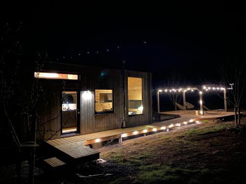 a cabin lit up at night with lights on it at Tinyhouse au coeur d'un vignoble in Floreffe