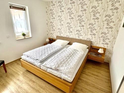 a bedroom with a bed and a window at Villa Weißer Schwan in Trent