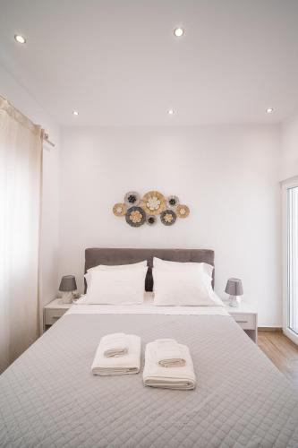 a bedroom with a large bed with two towels on it at Kyra's Luxury Suites 3 in Chios