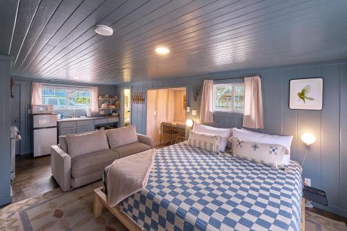 a bedroom with a bed and a couch and a kitchen at The Nest #8 in Long Beach