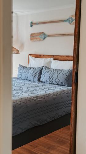 a bedroom with a bed with a wooden frame at Can Jan Vives in Vidreres