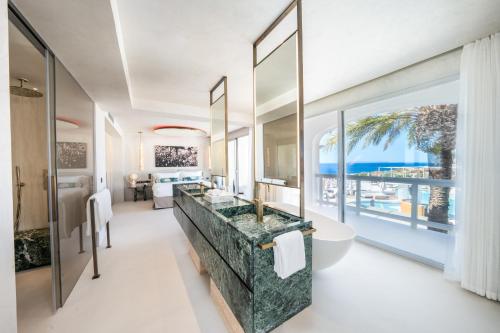a bathroom with a view of the ocean at Destino Five Ibiza - 5-Star Grand Luxe Resort in Talamanca
