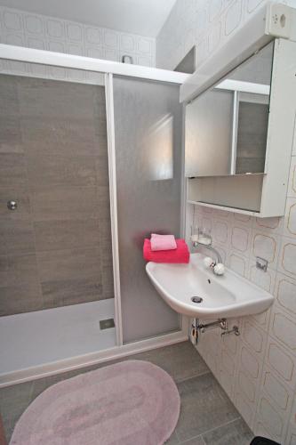 a bathroom with a sink and a shower at Alle Vigne, 1 Stock by HolAp SA in Ascona