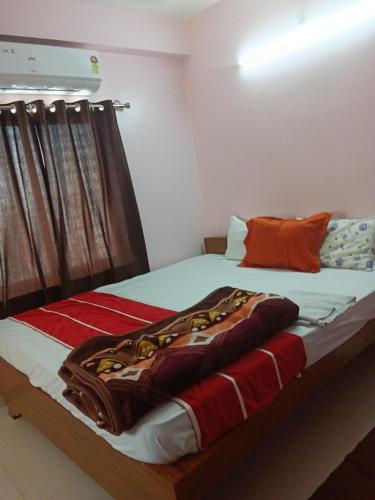 a bedroom with a large bed with at Hotel parijaye 