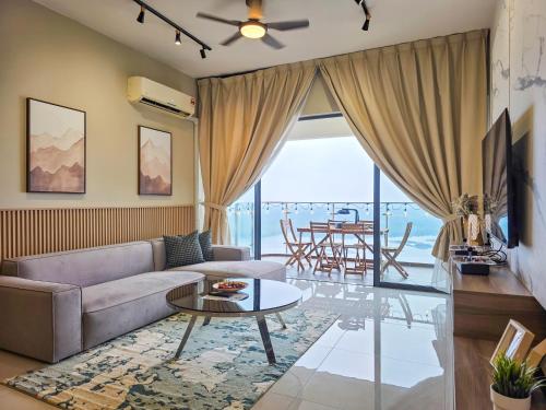 a living room with a couch and a table at Country Garden Seaview Suite by Nest Home at Danga Bay in Johor Bahru