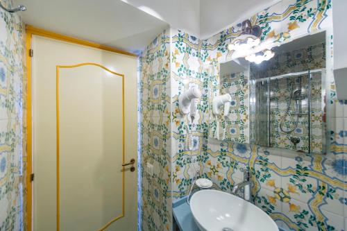 a bathroom with a sink and a mirror at Hotel Costa Diva in Praiano