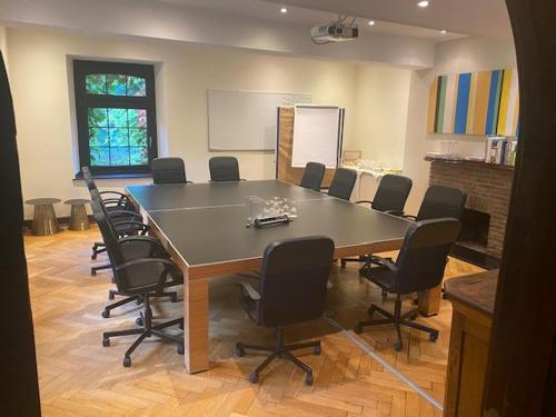 a conference room with a large table and chairs at Burg Wegberg Hotel & Eventlocation in Wegberg
