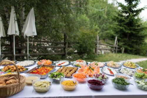 a table with many plates of food on it at Hotel Wieslhof in Collepietra