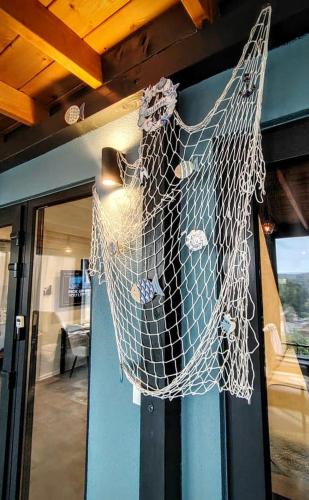 a net hanging on the side of a door at Sea view BluEscape by Vellaris, Luxury Mobile Home in Mali Lošinj