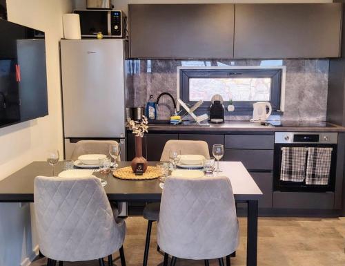 a kitchen with a table and chairs in a kitchen at Sea view BluEscape by Vellaris, Luxury Mobile Home in Mali Lošinj
