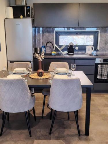 a kitchen with a table and chairs in a kitchen at Sea view BluEscape by Vellaris, Luxury Mobile Home in Mali Lošinj