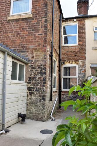 a brick building with a door and a garage at Grace home by Esongrace stays in Stoke on Trent