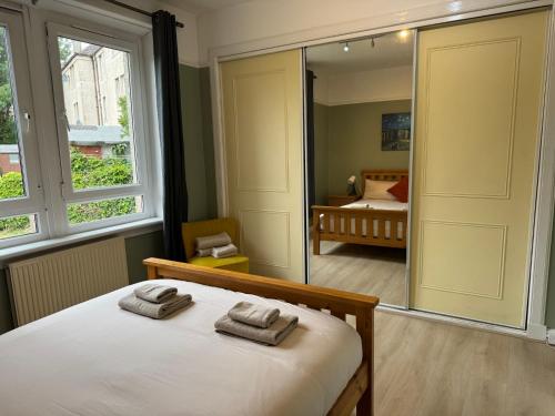 a bedroom with a bed with two towels on it at Peaceful City Centre Retreat at Great location and Easy Access in Edinburgh