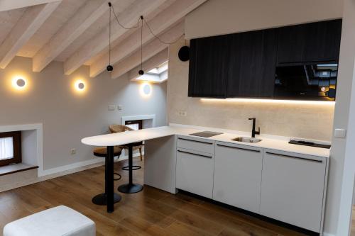 a kitchen with white cabinets and a counter top at La Barata Apartamentos in Colombres