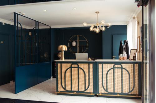 a room with blue walls and a desk with a laptop at La Caravelle in Aix-en-Provence
