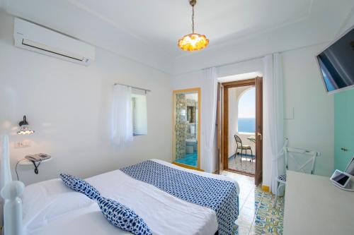a bedroom with a bed and a view of the ocean at Hotel Costa Diva in Praiano