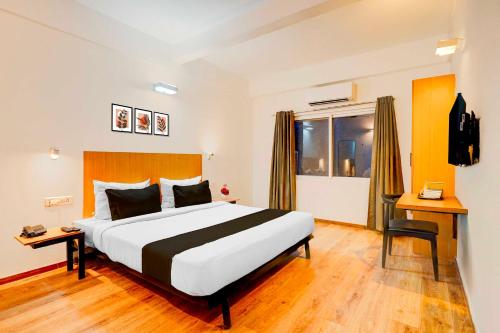 a hotel room with a large bed and a window at Townhouse Oak HAL Heritage Center in Bengaluru
