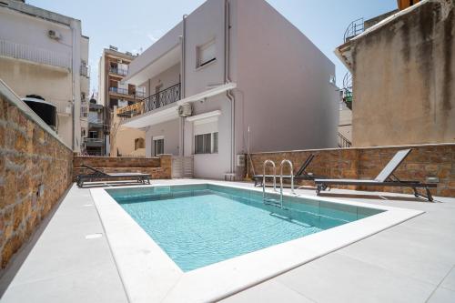a swimming pool on the roof of a building at Kyra's Luxury Suites 4 in Chios
