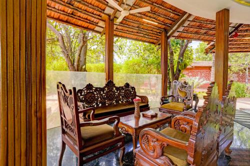 a screened in porch with a table and chairs at Townhouse Palghar in Talāsri