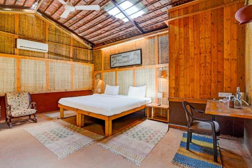 a bedroom with a bed and a table and a chair at Townhouse Palghar in Talāsri