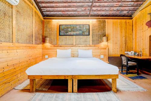 a bedroom with a bed in a wooden room at Townhouse Palghar in Talāsri
