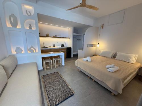 a bedroom with a bed and a living room at Panorama Rooms in Anafi
