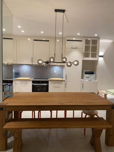 a kitchen with a wooden table and a dining room at Tegernsee modern apartment, free parking in Tegernsee
