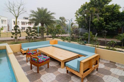 a patio with a table and chairs next to a pool at Ametsa in Amritsar