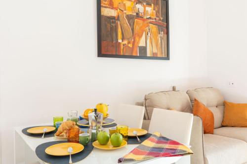a dining room table with plates of food on it at Orange y Lemon in Sant'Agnello