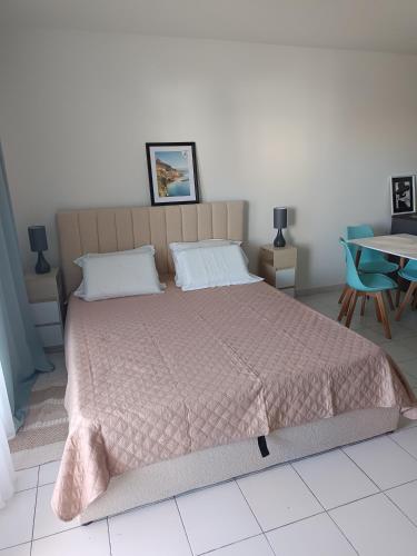 - une chambre avec un grand lit et une couette rose dans l'établissement Nice studio 5 minutes walk from the beach, à Cagnes-sur-Mer